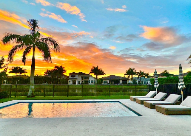 view of pool at dusk