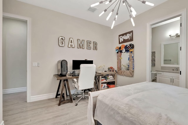 bedroom with light hardwood / wood-style flooring and a notable chandelier