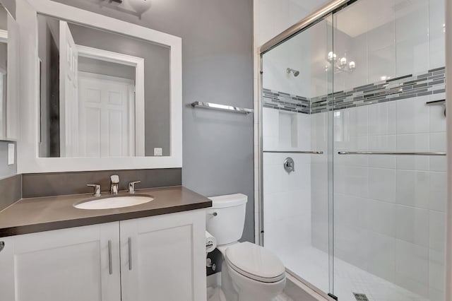 bathroom featuring walk in shower, vanity, and toilet