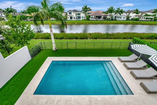 view of pool featuring a yard and a water view