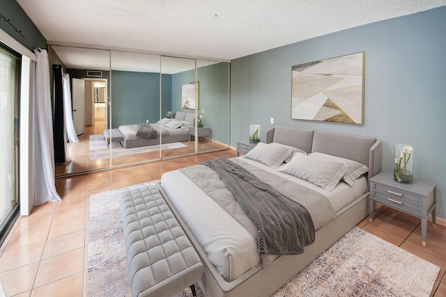 tiled bedroom with a textured ceiling