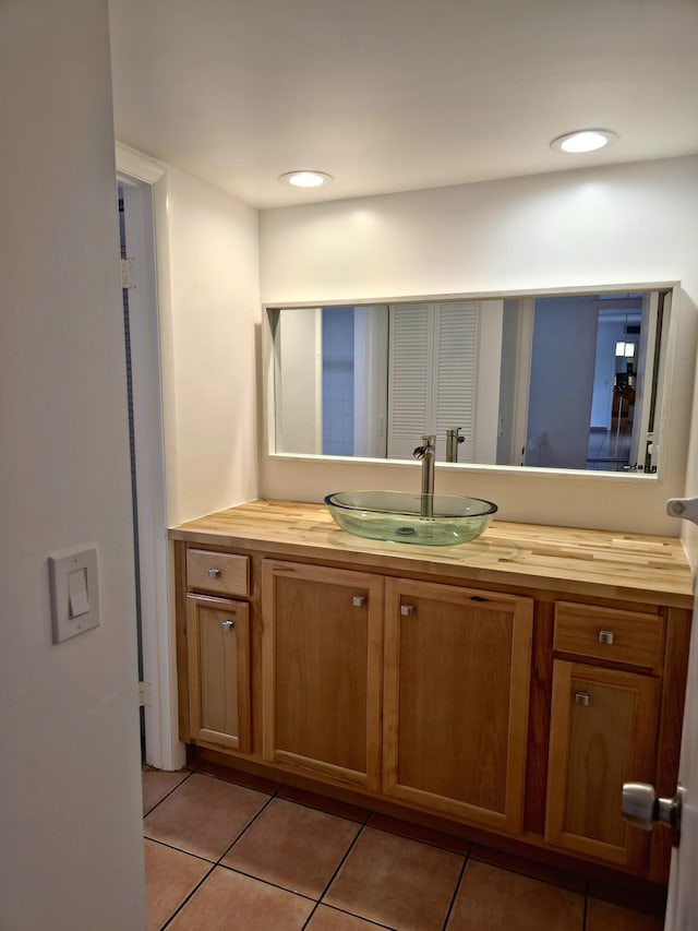 bathroom with tile patterned floors, vanity, and recessed lighting