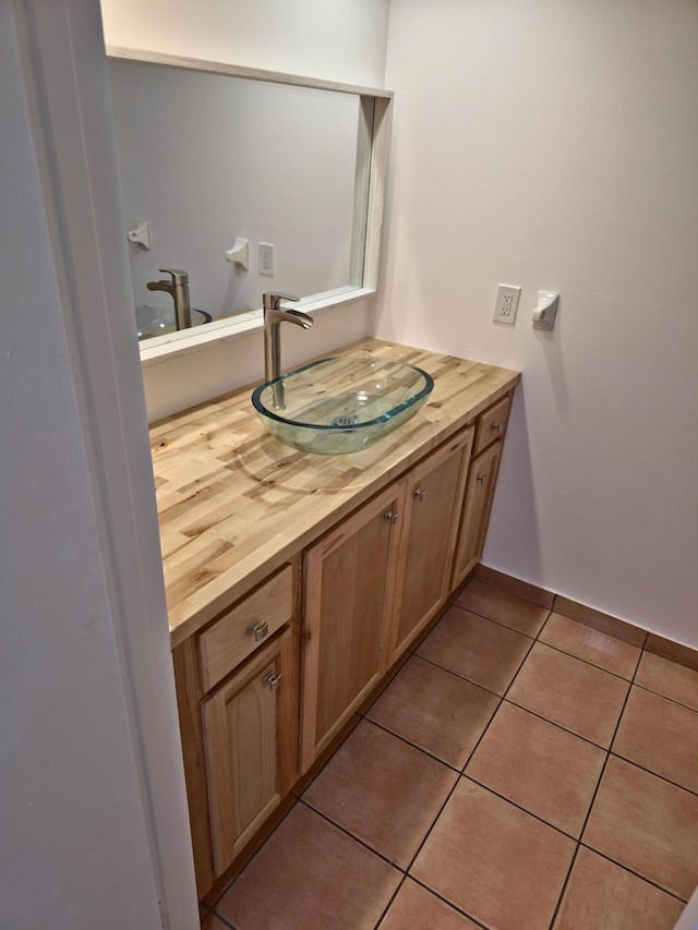 bathroom with tile patterned floors and vanity