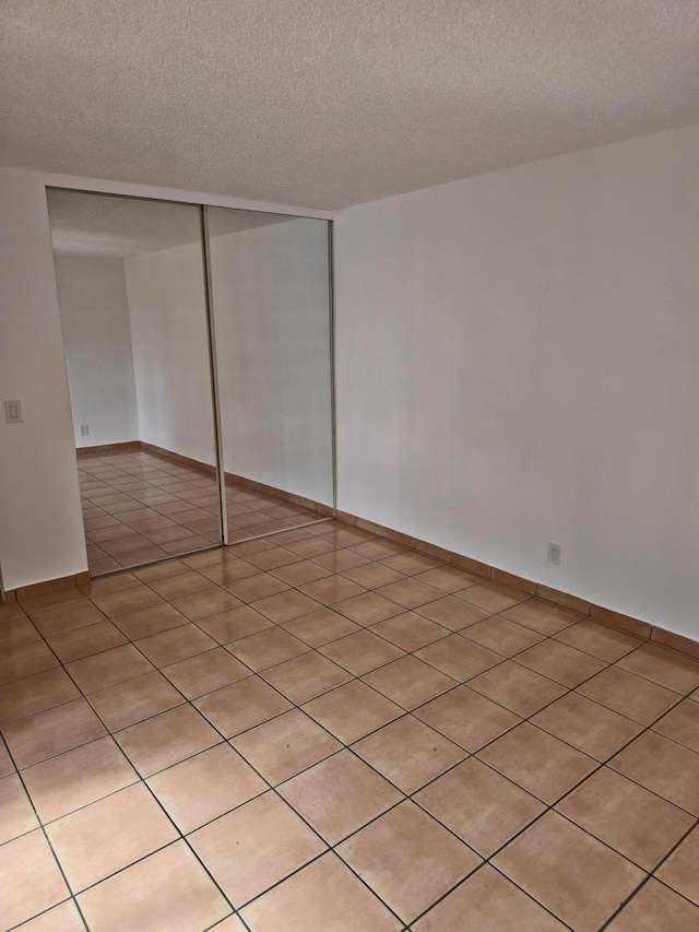 interior space with a closet and a textured ceiling