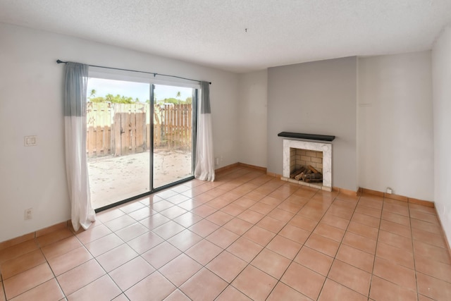 unfurnished living room featuring a textured ceiling and light tile patterned floors