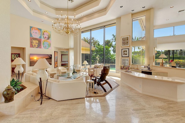 interior space featuring a wealth of natural light, a chandelier, a tray ceiling, and a towering ceiling