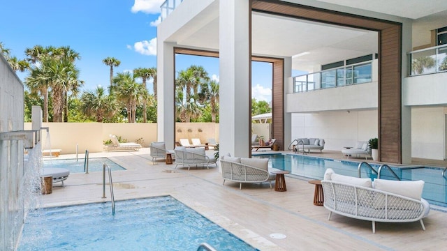 view of pool with a patio area, pool water feature, and an outdoor hangout area