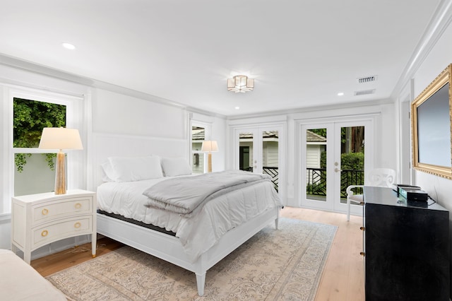 bedroom with french doors, ornamental molding, light hardwood / wood-style flooring, and access to exterior