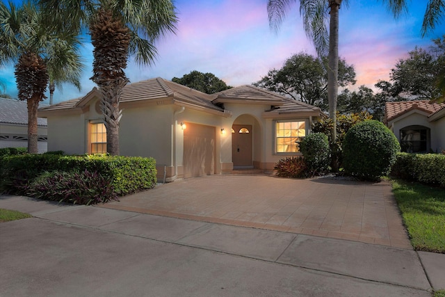 mediterranean / spanish-style home with a garage