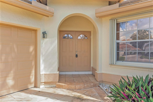 view of exterior entry featuring a garage