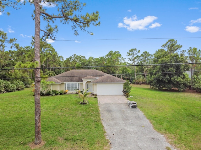 view of front of property with a front yard and a garage