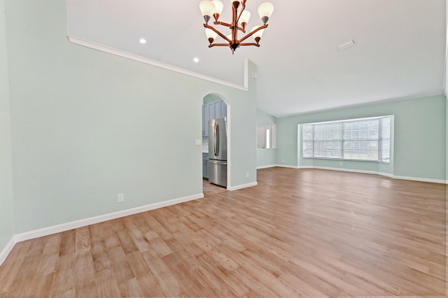 unfurnished living room with ornamental molding, light hardwood / wood-style flooring, and an inviting chandelier