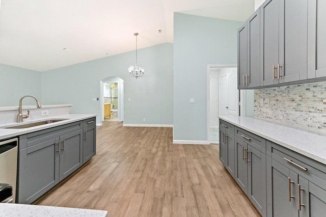 kitchen featuring light hardwood / wood-style floors, sink, stainless steel dishwasher, and gray cabinets