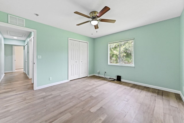 unfurnished bedroom with a closet, light wood-type flooring, and ceiling fan