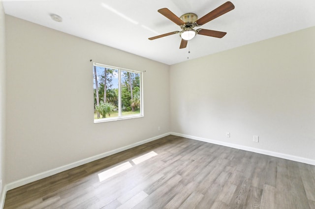 spare room with light hardwood / wood-style floors and ceiling fan