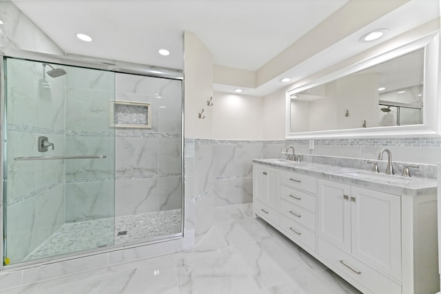 bathroom featuring tile walls, vanity, and an enclosed shower