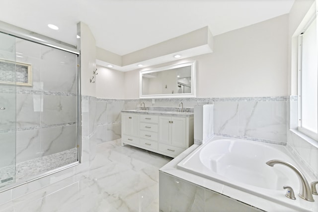 bathroom with vanity and separate shower and tub