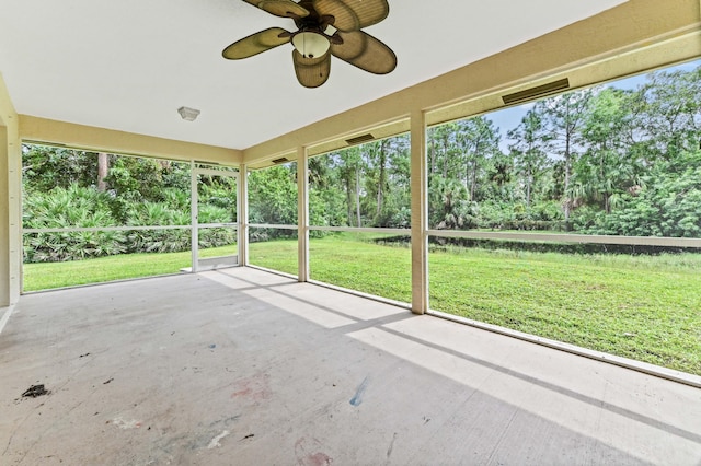 unfurnished sunroom featuring ceiling fan