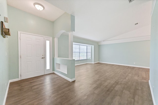 entrance foyer featuring vaulted ceiling and dark hardwood / wood-style floors