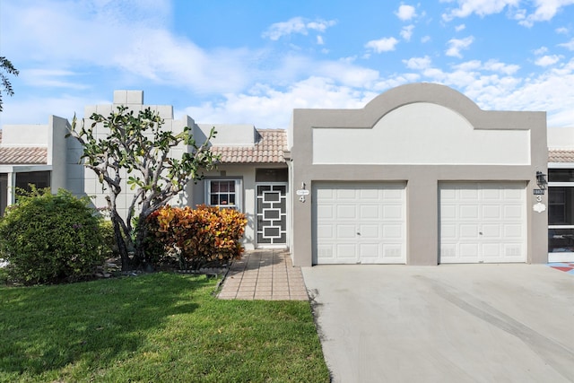 view of front of property with a front yard and a garage