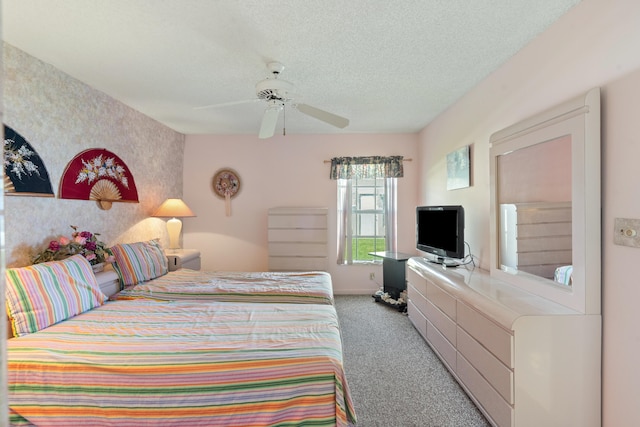 carpeted bedroom featuring a textured ceiling and ceiling fan