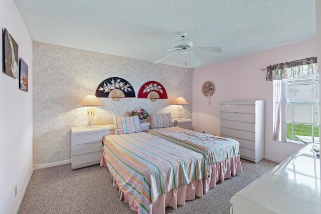 carpeted bedroom with ceiling fan and a textured ceiling