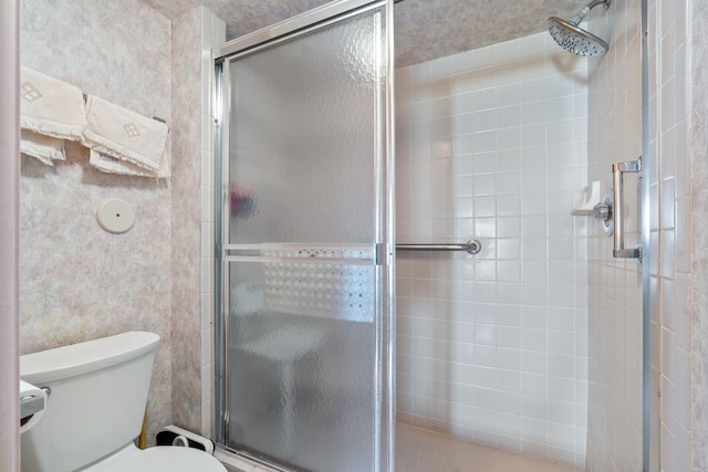 bathroom with toilet and walk in shower