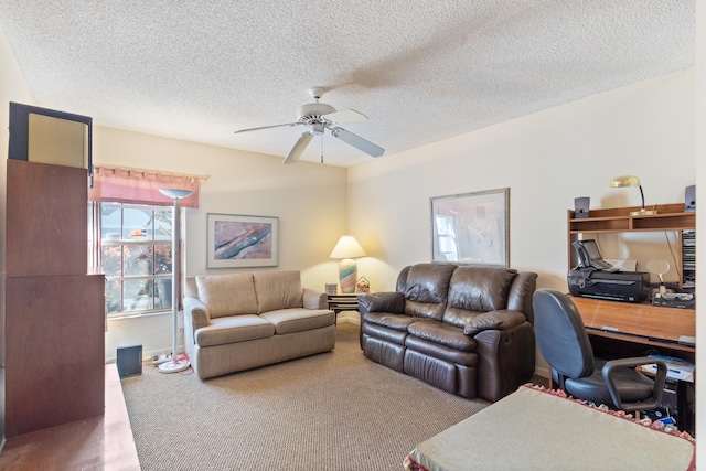 living room with a textured ceiling, carpet flooring, and ceiling fan