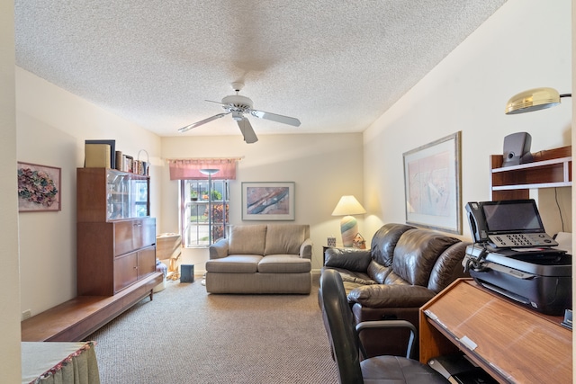 living room featuring a textured ceiling, carpet flooring, and ceiling fan