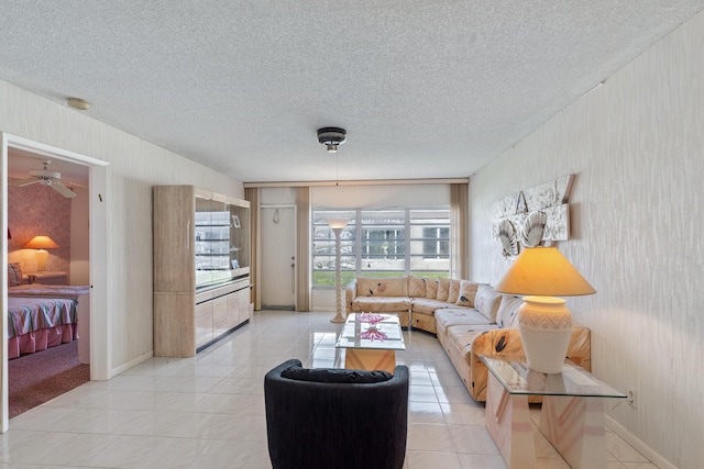 living room featuring light tile patterned flooring and a textured ceiling