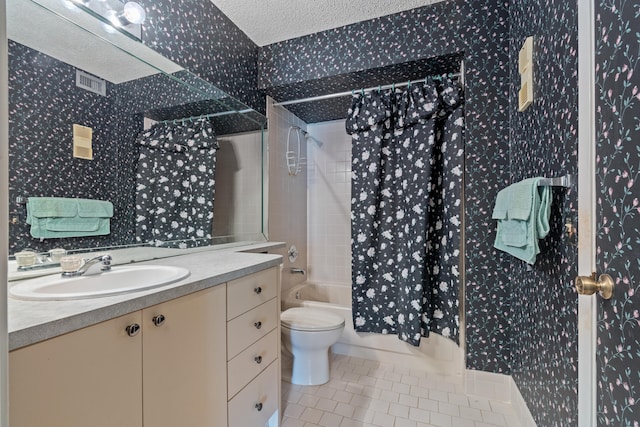 full bathroom featuring a textured ceiling, toilet, shower / bath combo with shower curtain, vanity, and tile patterned flooring