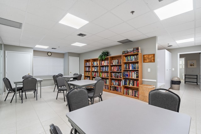 dining area featuring a drop ceiling