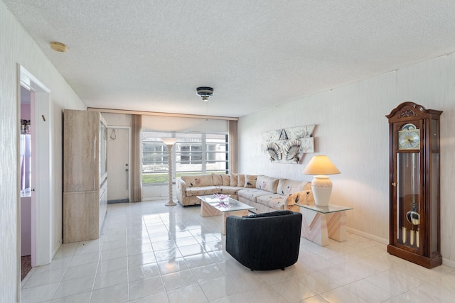 living room featuring a textured ceiling and light tile patterned floors