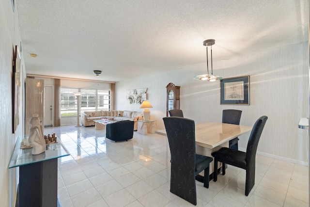 dining room featuring a textured ceiling and light tile patterned flooring