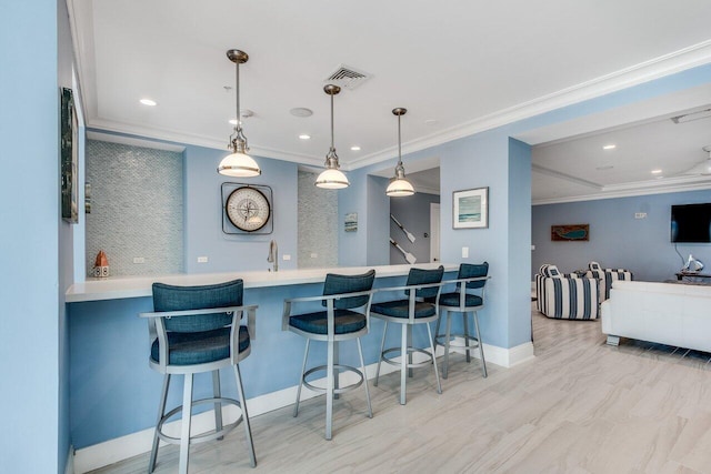 kitchen featuring a breakfast bar, kitchen peninsula, crown molding, and pendant lighting