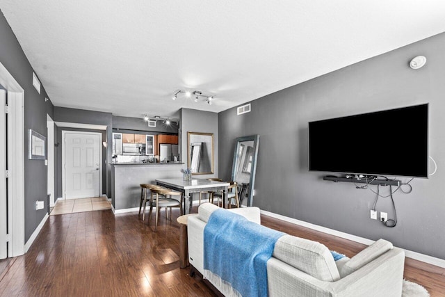 living room with wood-type flooring and a textured ceiling