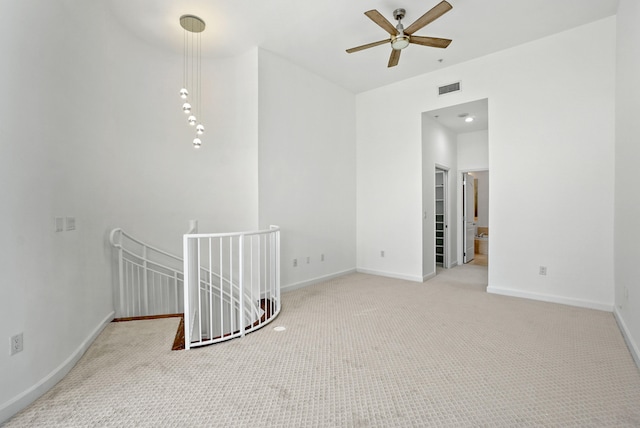 unfurnished room featuring light carpet and ceiling fan