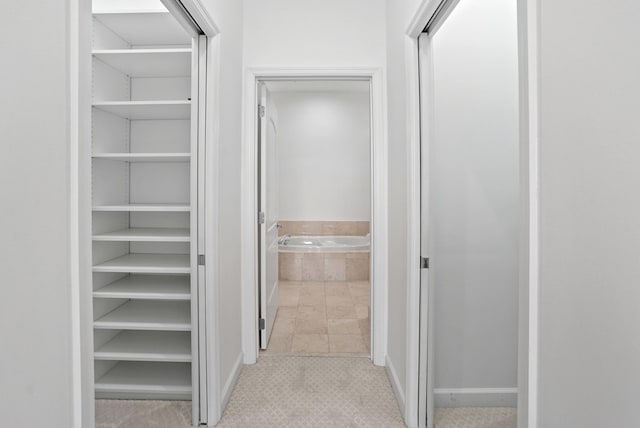 hall featuring light tile patterned floors