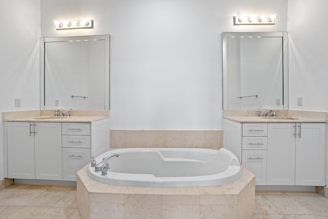 bathroom with vanity and a relaxing tiled tub