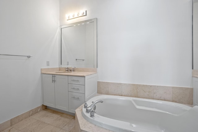 bathroom with vanity and tiled tub