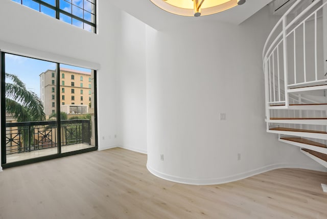 unfurnished living room with a wealth of natural light and light wood-type flooring