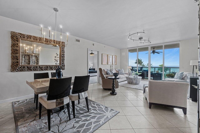 dining room with ceiling fan with notable chandelier and light tile patterned floors