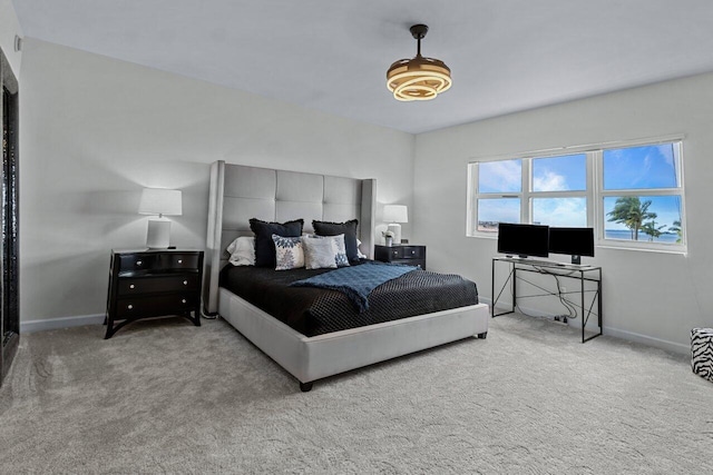 bedroom featuring light colored carpet