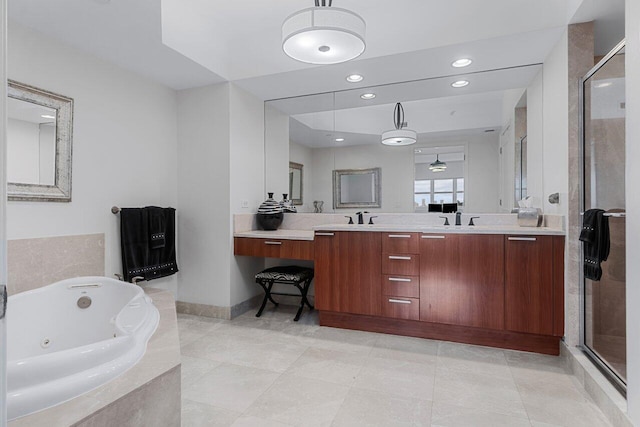 bathroom featuring shower with separate bathtub, vanity, and tile patterned floors