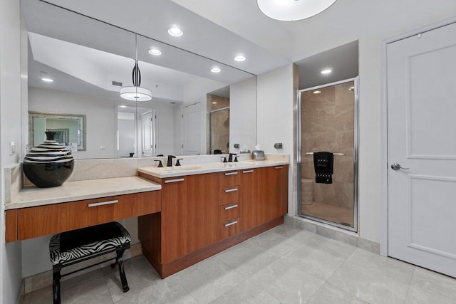 bathroom featuring a shower with door, vanity, and tile patterned flooring