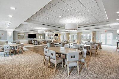 carpeted dining area featuring a paneled ceiling