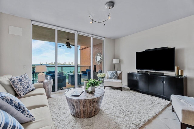 tiled living room with a wall of windows and ceiling fan