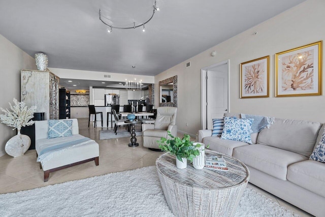 living room with an inviting chandelier and light tile patterned floors