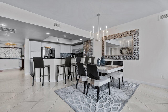 dining space with a chandelier and light tile patterned floors