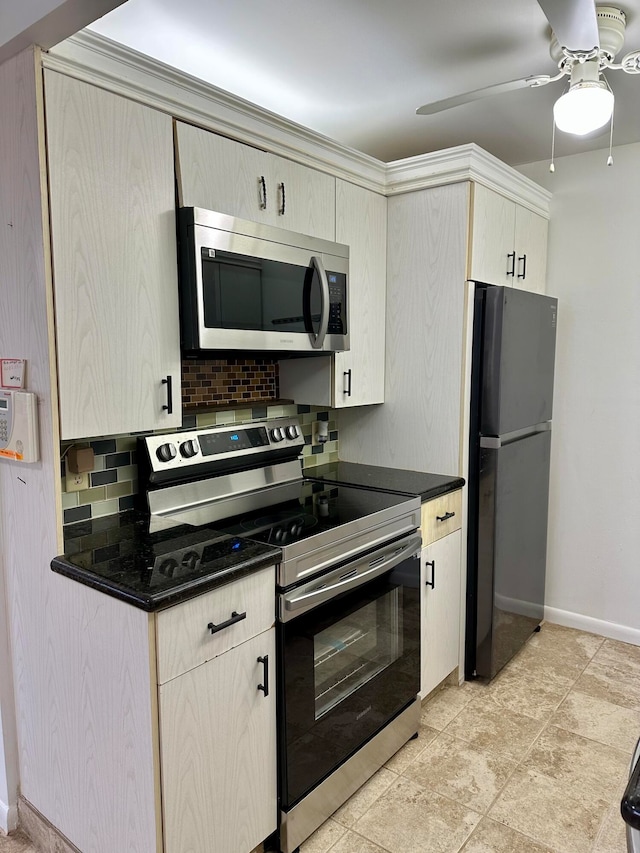 kitchen featuring ceiling fan, stainless steel appliances, decorative backsplash, and cream cabinetry